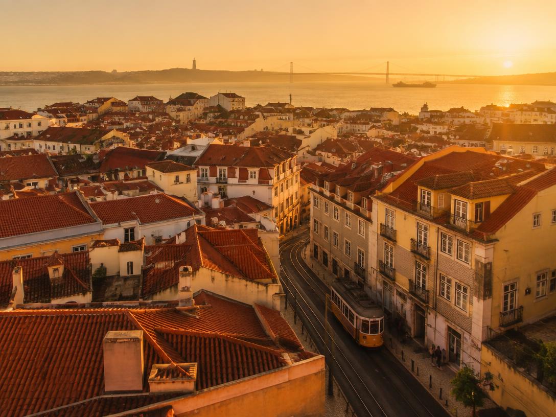 Tram and rooftops of Lisbon at sunset